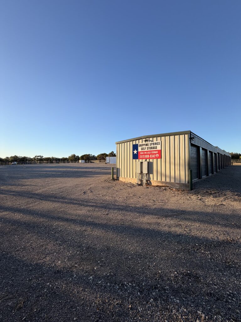 Storage office building with Texas flag sign and keypad entry at Dripping Springs Self Storage