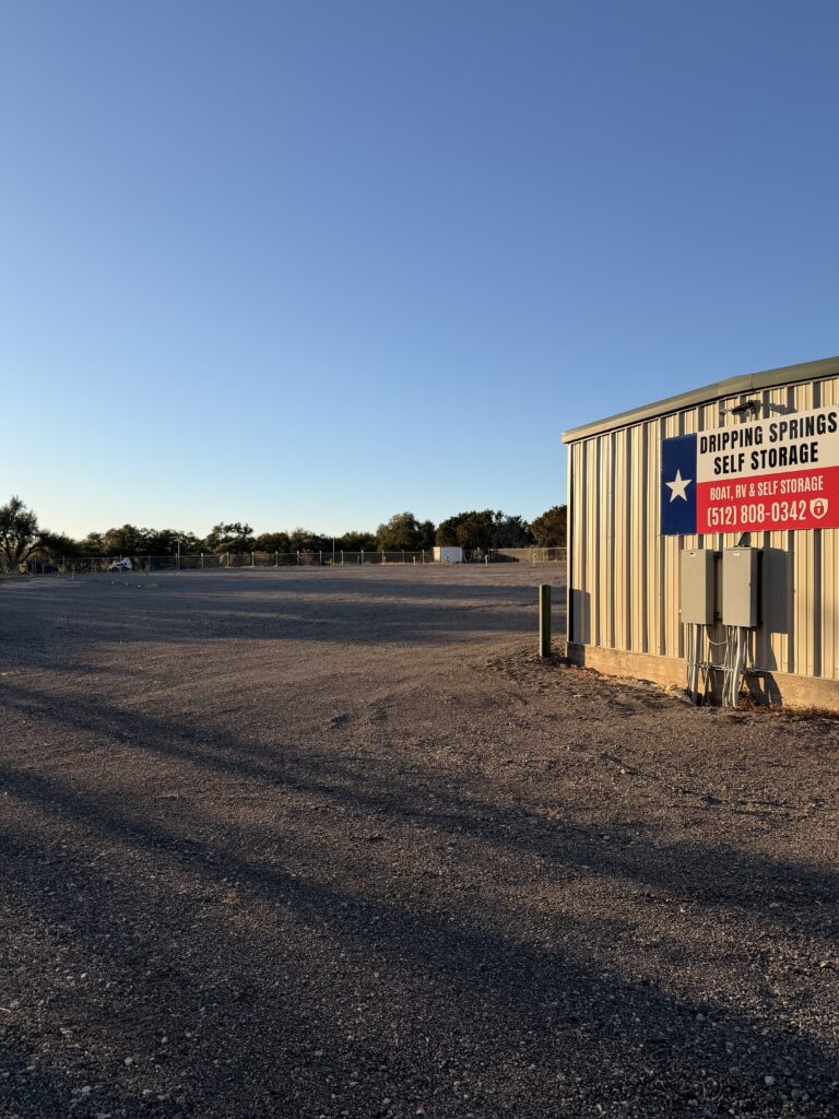Storage office building with Texas flag sign and keypad entry at Dripping Springs Self Storage